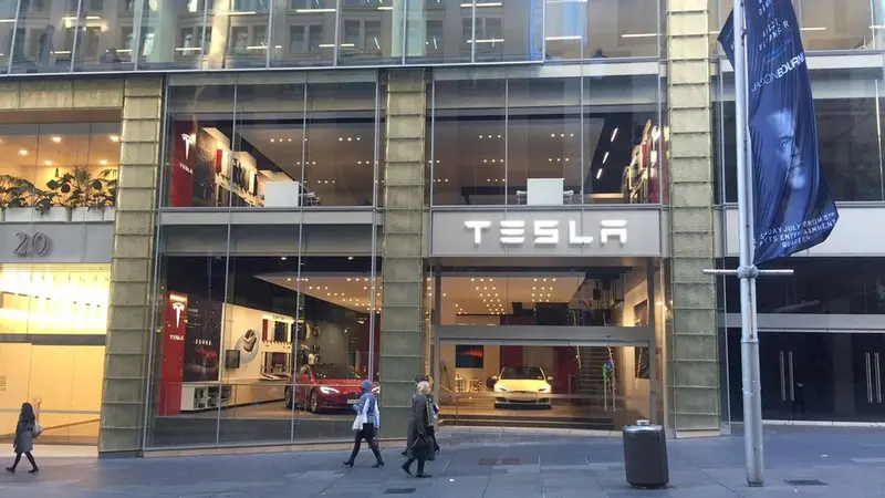 The Tesla store front on a Sydney CBD street, a red Model S in the window