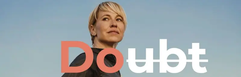 Confident woman against a blue sky with the word 'Doubt' and 'ubt' struck through to leave 'Do'