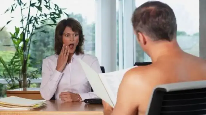 Shocked interviewer with hand over mouth facing a naked job candidate holding a CV